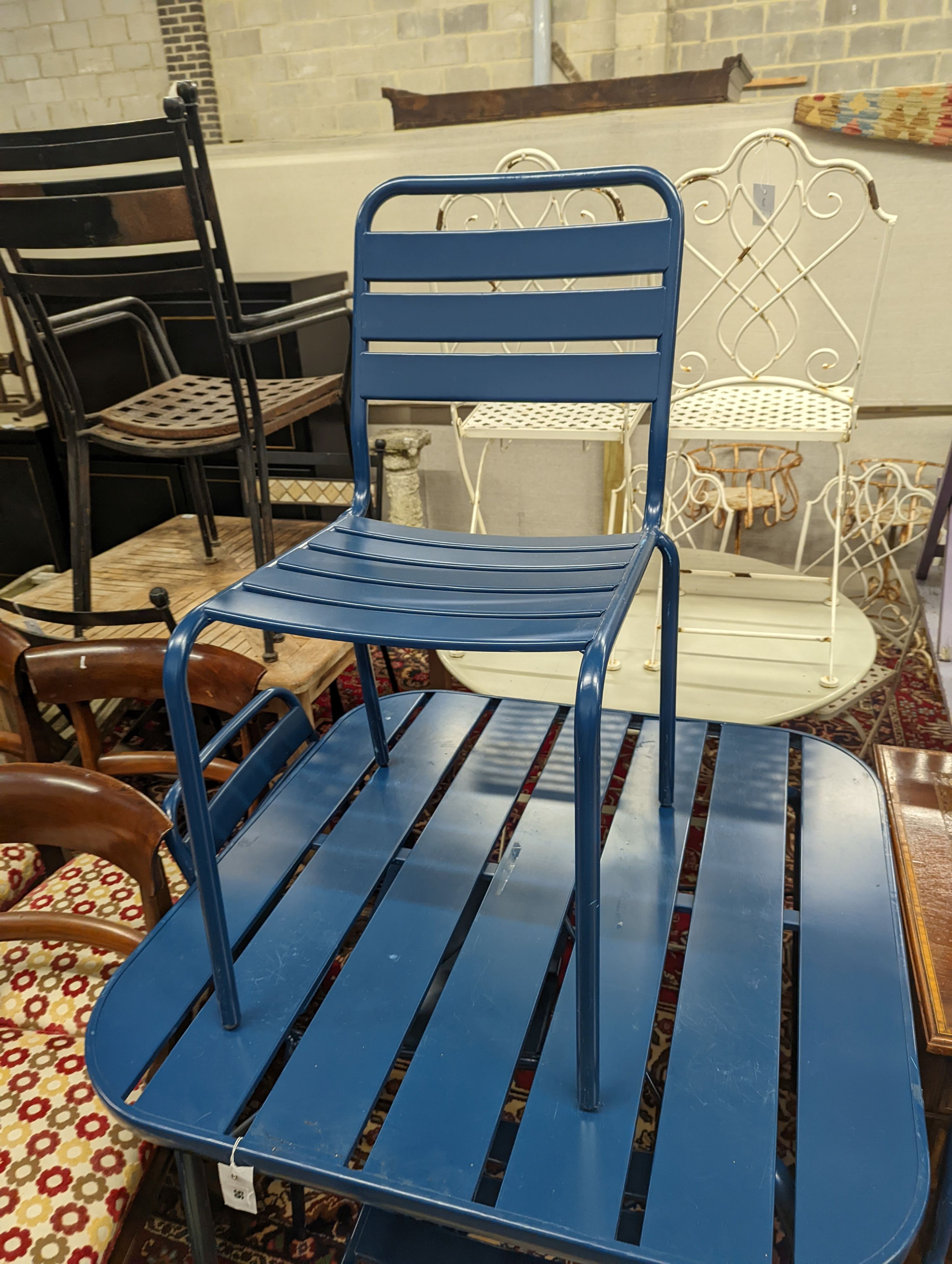 A square painted metal garden table, width 90cm, height 74cm and four matching chairs
